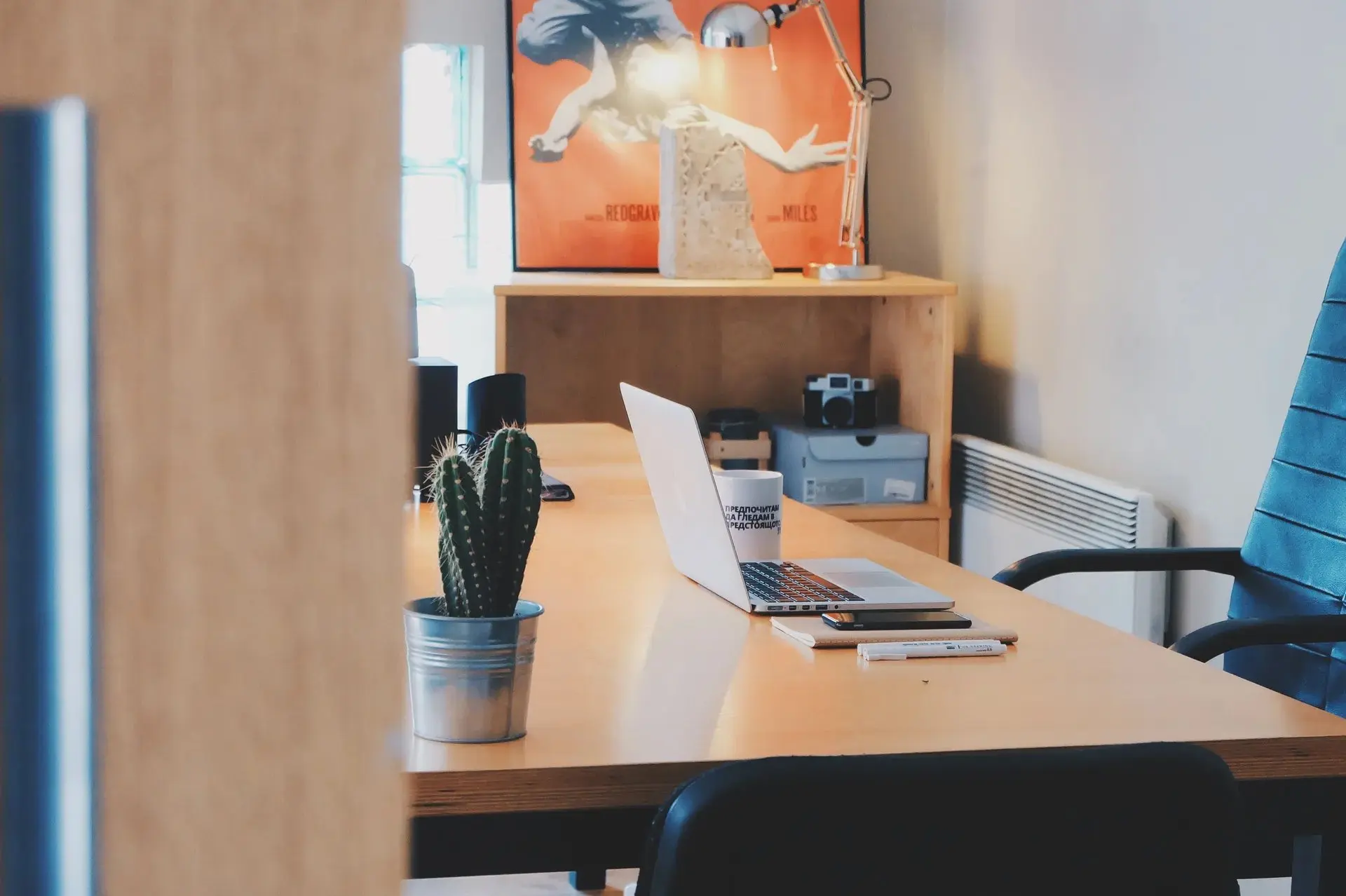 A laptop and notebook on a desk for contacting support